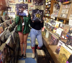 Employees at Play It Again Records hold up releases by Big Star and Mac DeMarco available on Record Store Day.